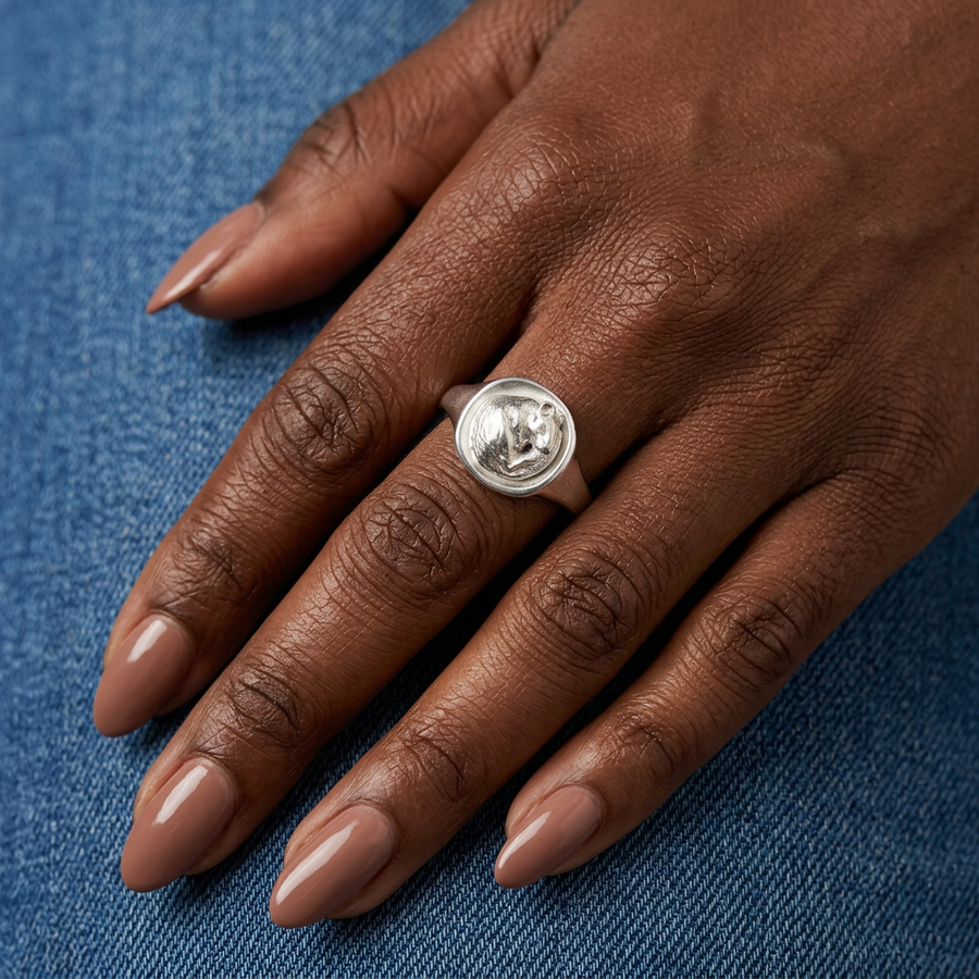 Rat signet ring on a Black model’s hand with manicured nails