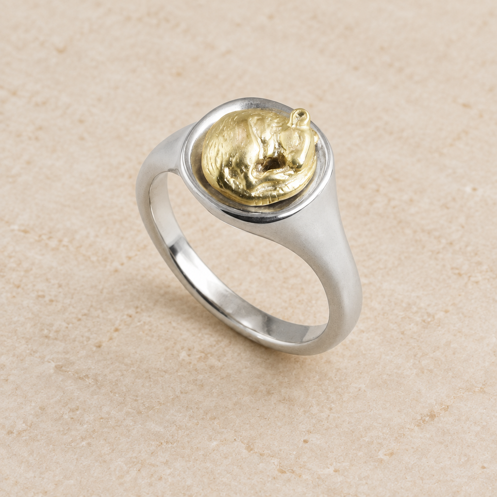Rat signet ring on soft beige stone