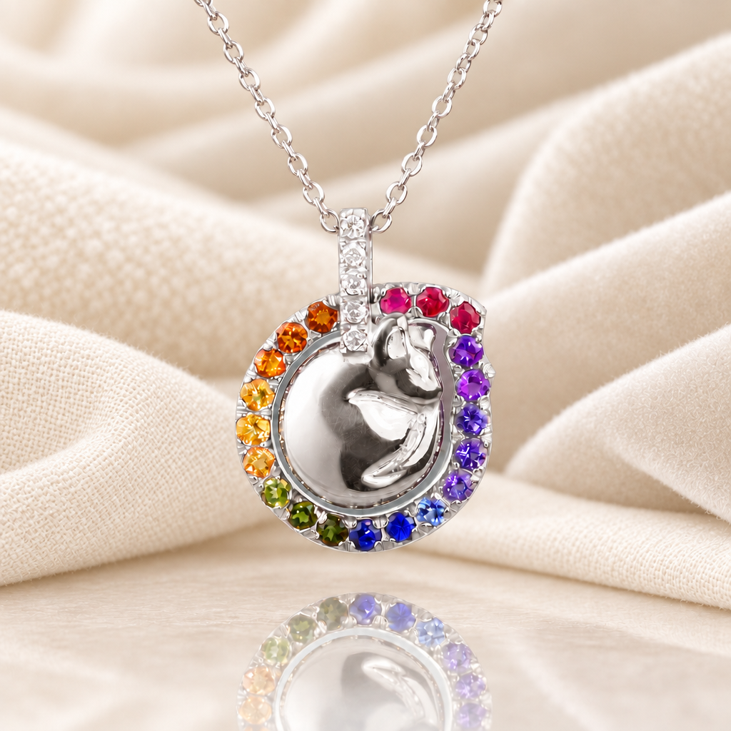 Platinum rainbow cat necklace on cream and white textiles